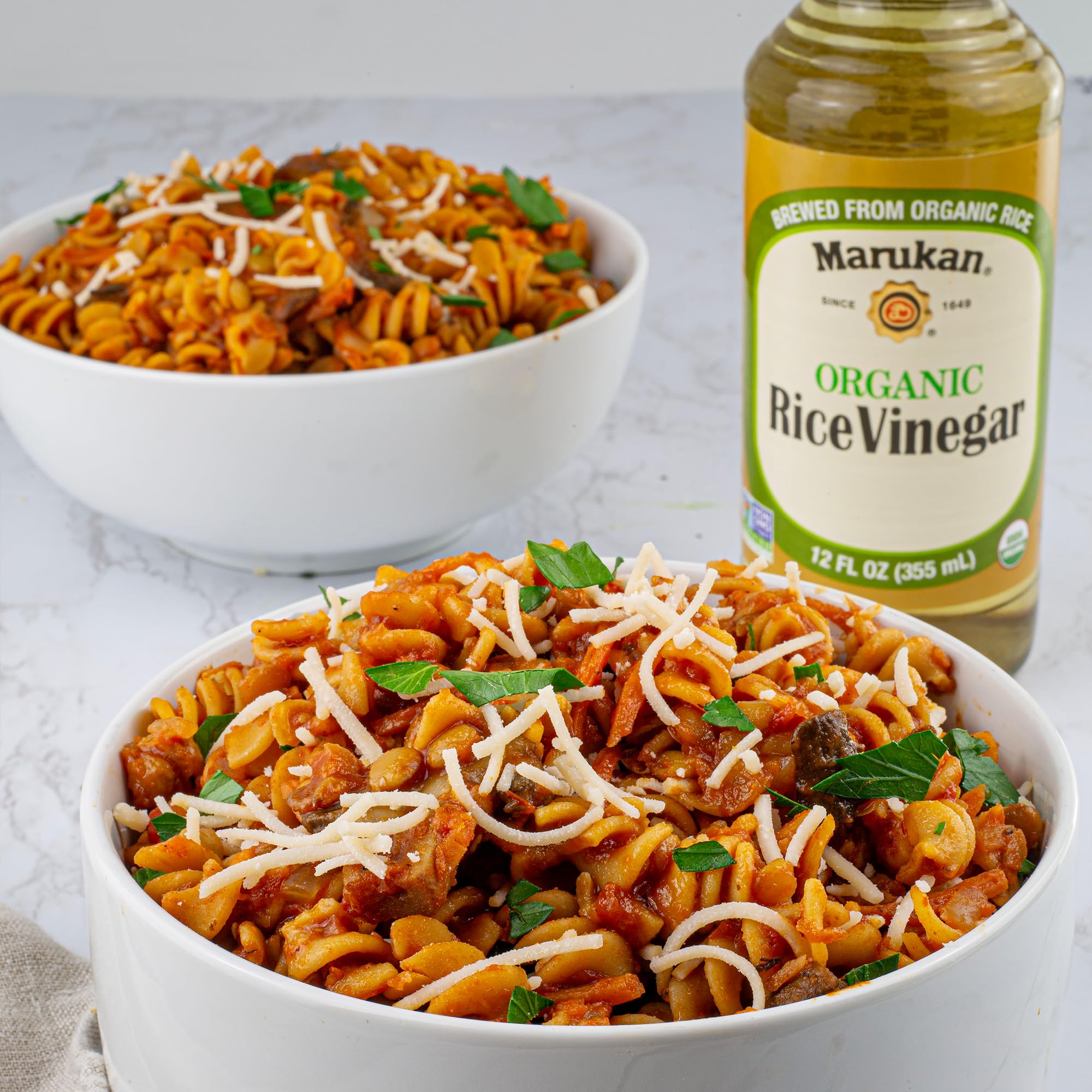 Kitchen scene with Marukan Organic Rice Vinegar suggesting versatile, gluten-free seasoning base.
