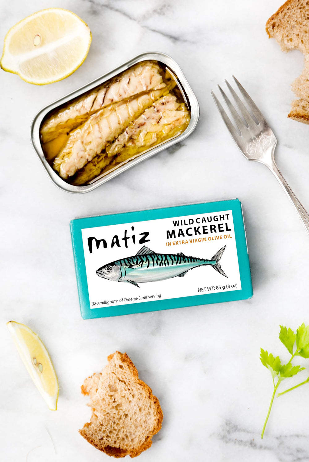 Close-up of Matiz mackerel in olive oil, emphasizing oil quality.
