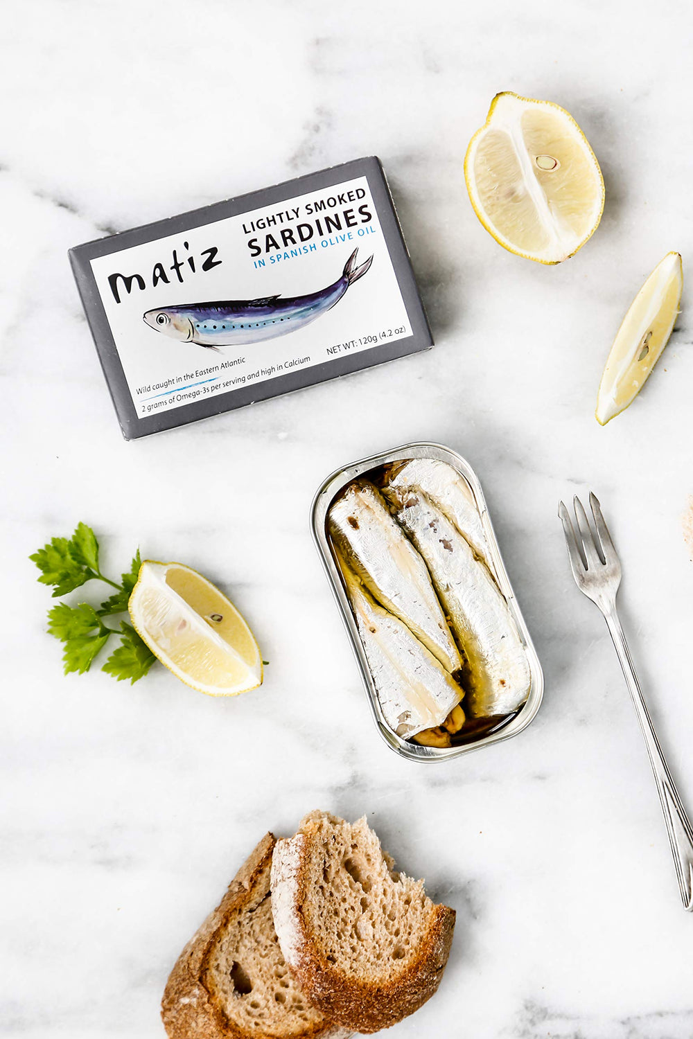 Matiz Sardines Lightly Smoked packaging and can display - gluten-free, non-GMO quality you can trust.