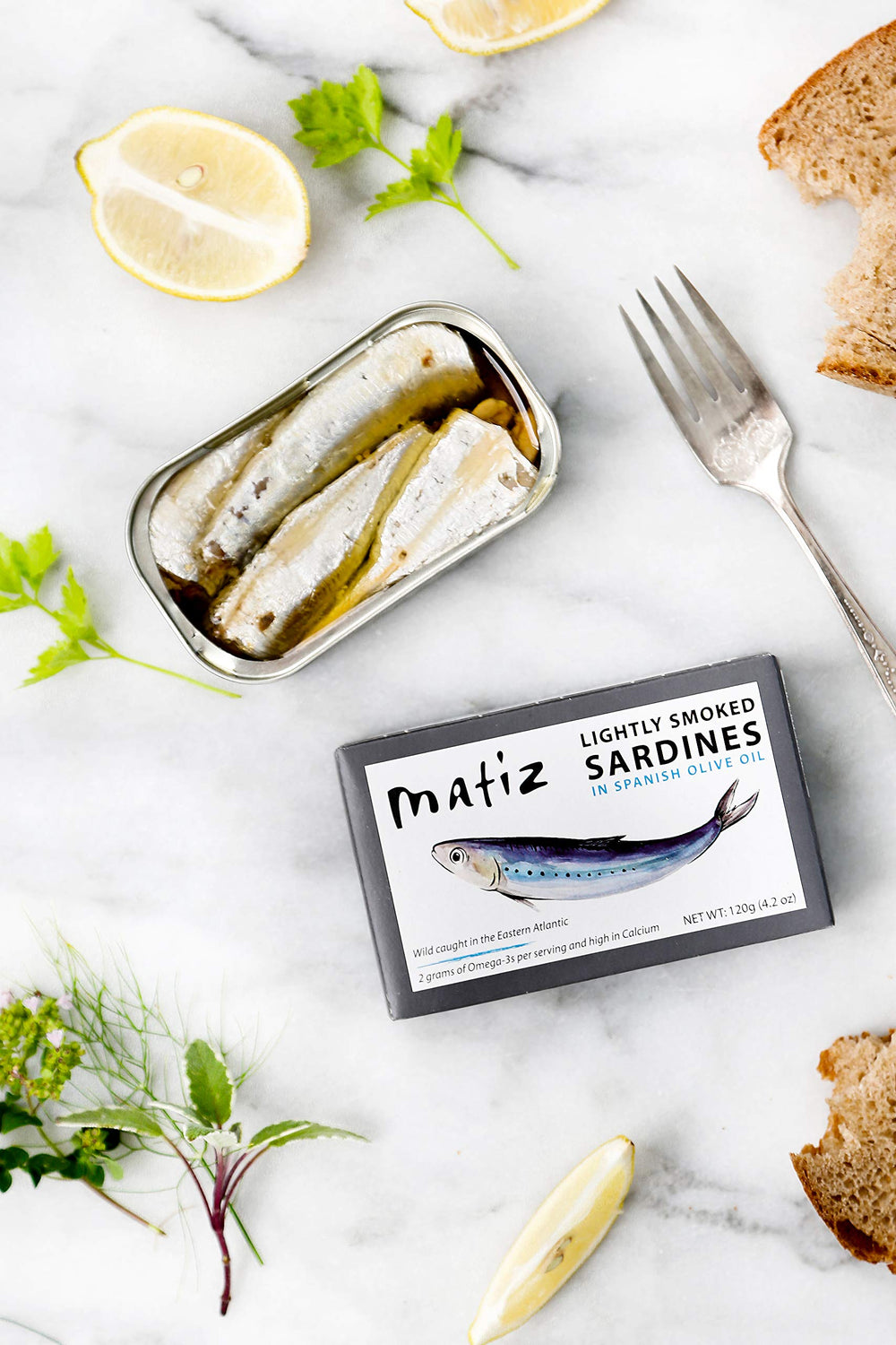 Matiz Sardines Lightly Smoked on tapas board - sophisticated snack with bold coastal flavor.