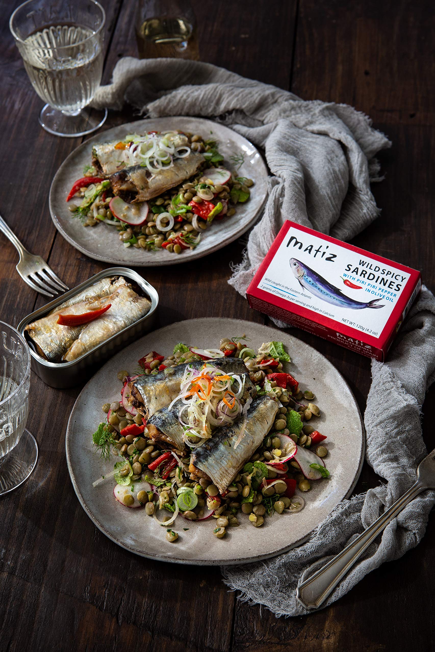 Matiz sardines paired with bread and onion, versatile serving idea.