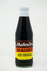 Matouk's Mauby 26oz bottle on table, ready for a refreshing sip.