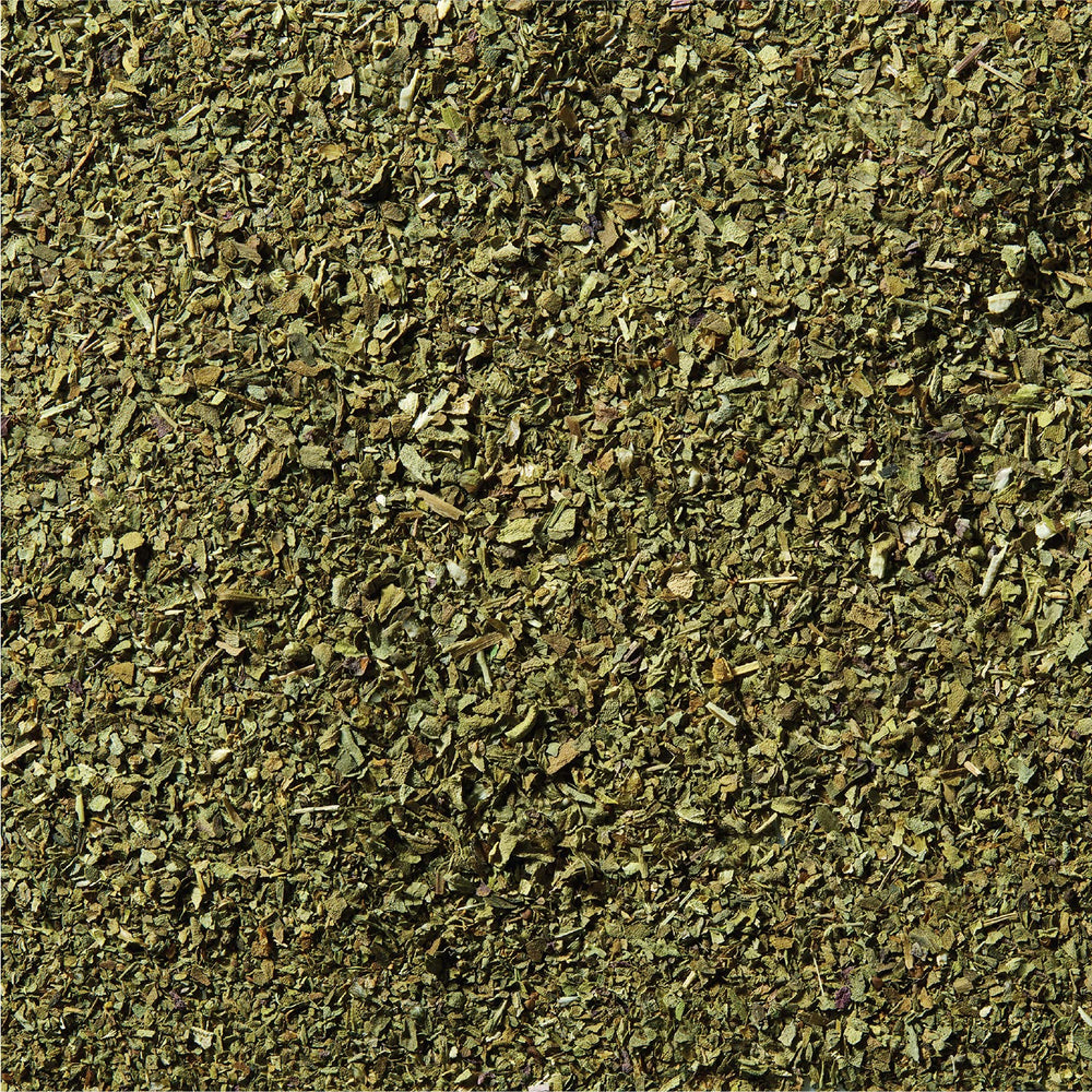 McCormick Basil Leaves rubbed between fingers releasing oils for richer flavor