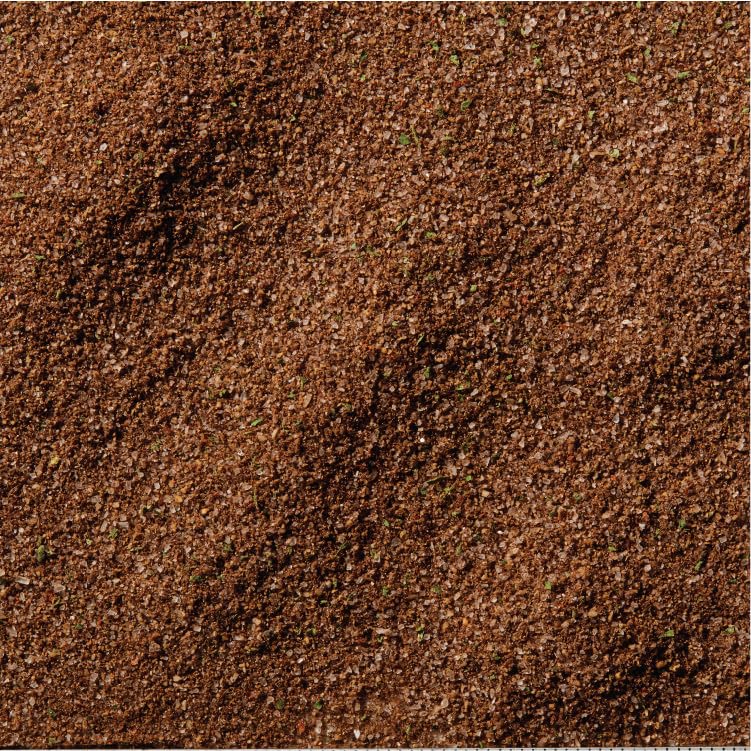 McCormick Black Garlic Powder Seasoning bottle pour demonstrates versatile use during cooking