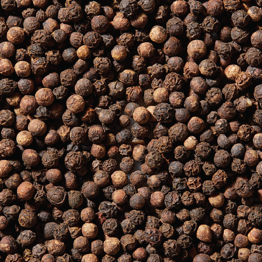 Crushed peppercorns in mortar for fresh blends