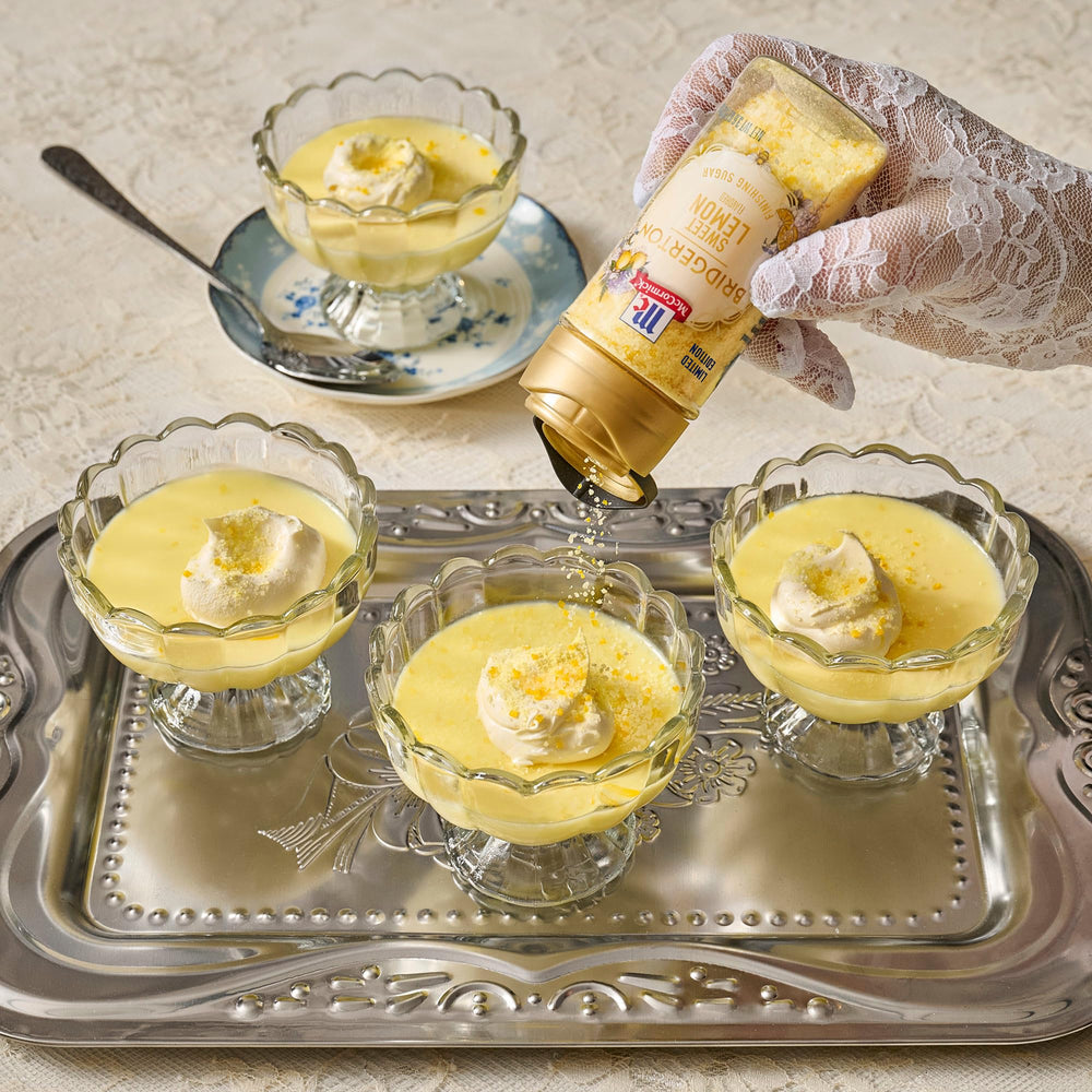 Bridgerton finishing sugar rimmed cocktail glass for zesty garnish.
