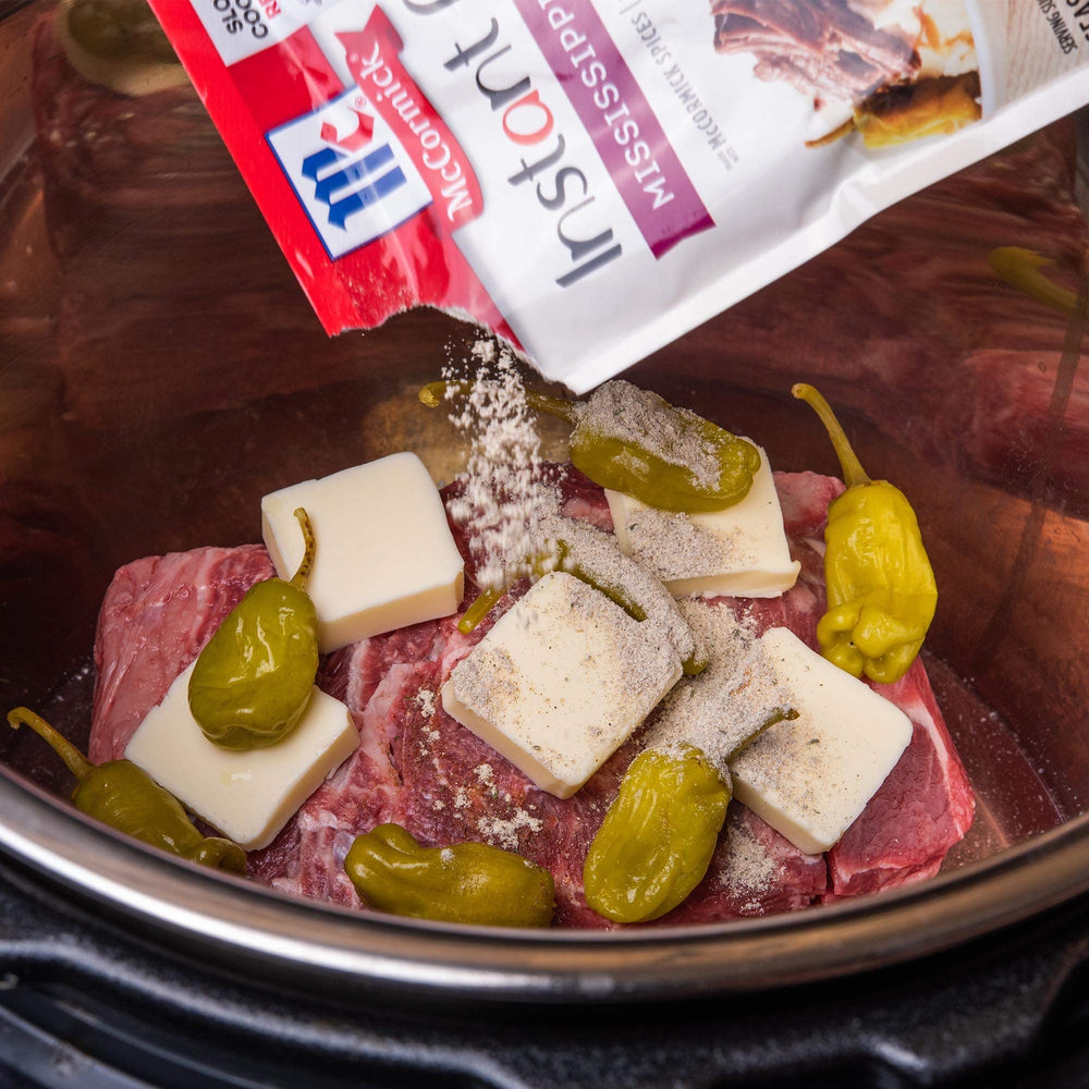 Butter and pepperoncini beside McCormick mix for rich roast flavor