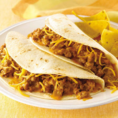 McCormick Cheesy Taco Seasoning on taco shells with toppings, ready to serve
