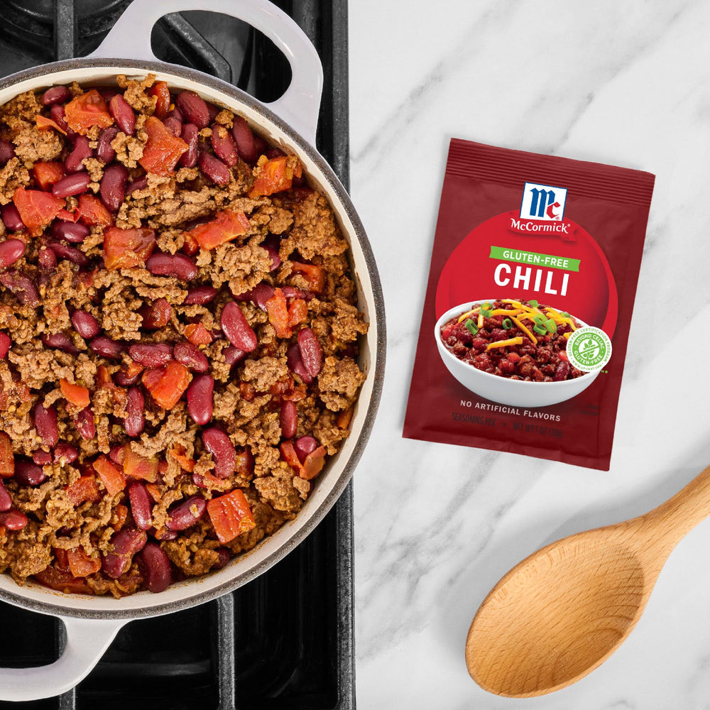 Serving bowl of chili topped with cheese using McCormick blend.