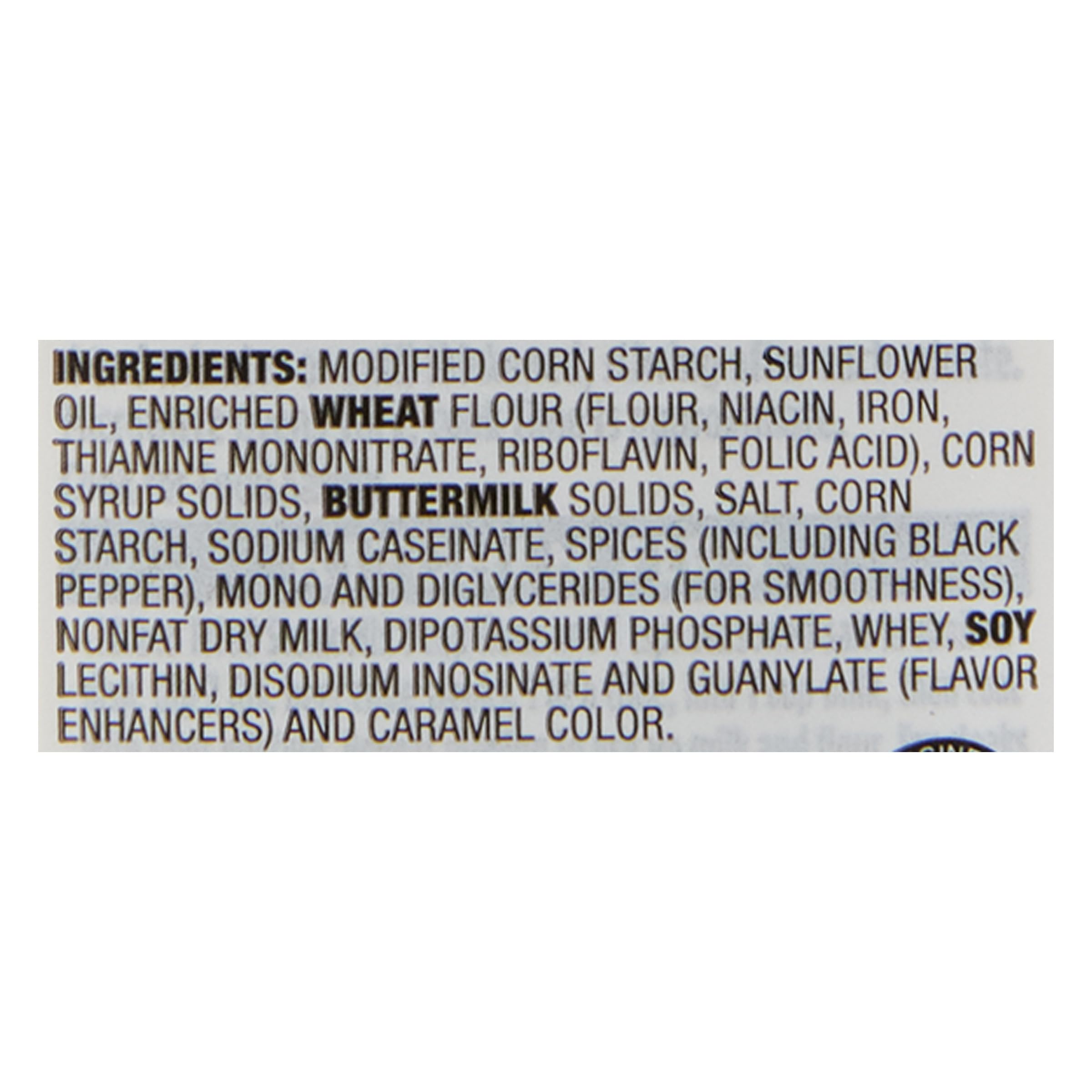 Stirring McCormick Country Gravy for a smooth, lump-free texture.