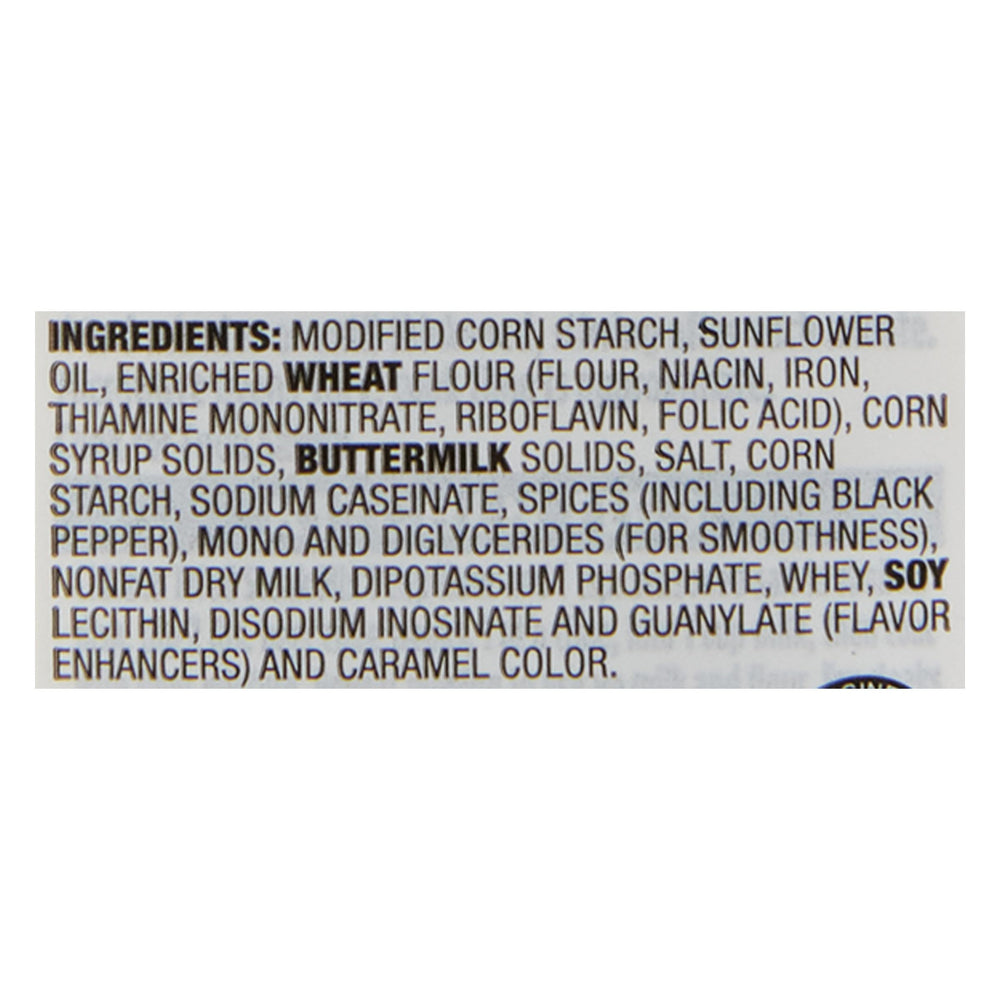 Stirring McCormick Country Gravy for a smooth, lump-free texture.