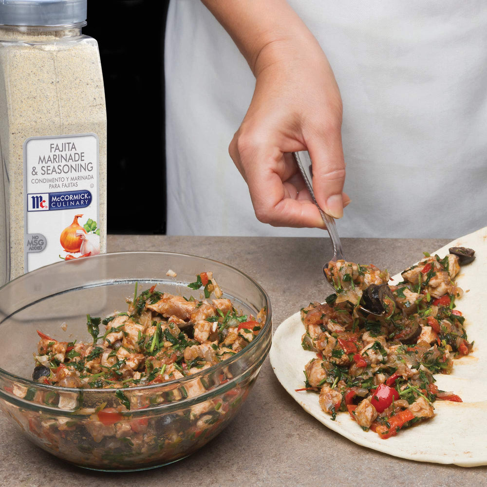 Chef in a professional kitchen using McCormick Culinary fajita seasoning