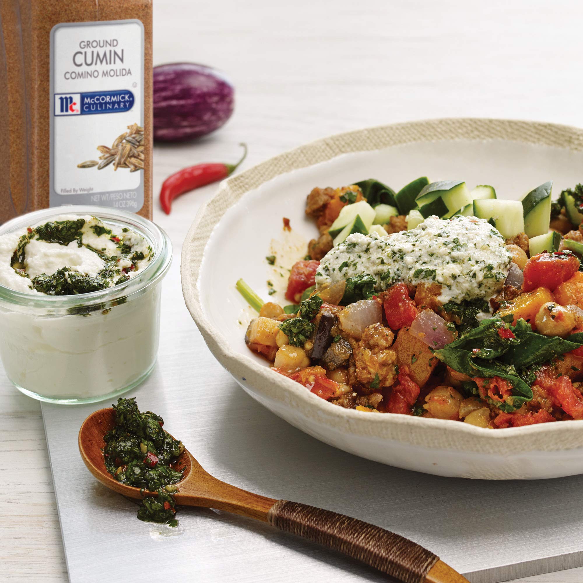 McCormick Culinary ground cumin dispensing cap enables quick seasoning.