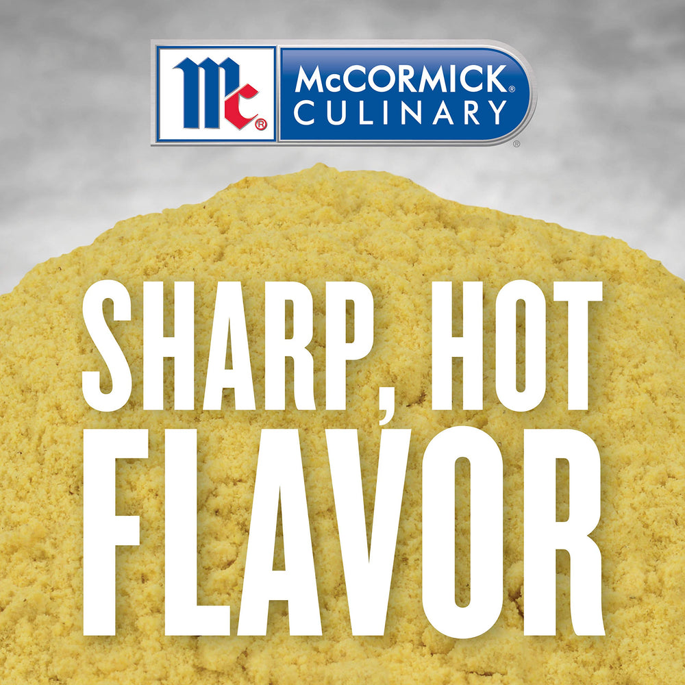 McCormick Culinary mustard powder in measuring cup for batch prep.
