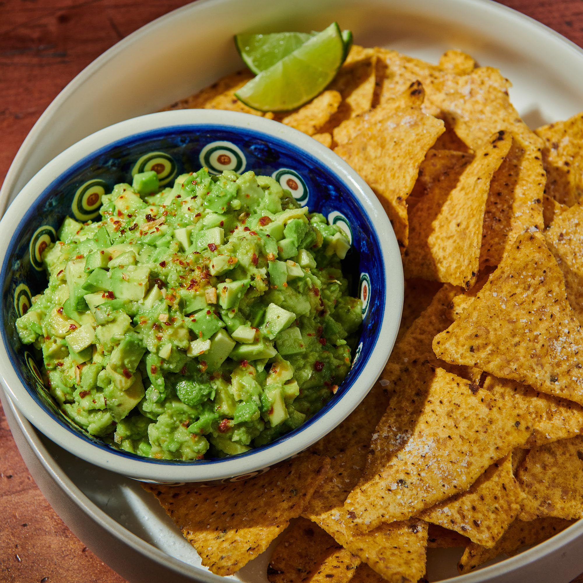 Sprinkling McCormick Culinary Guacamole and More Seasoning for easy flavor boost