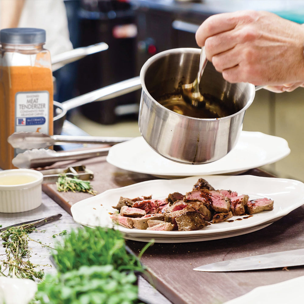 Applying McCormick Culinary tenderizer to meat before cooking demonstrates prep in action