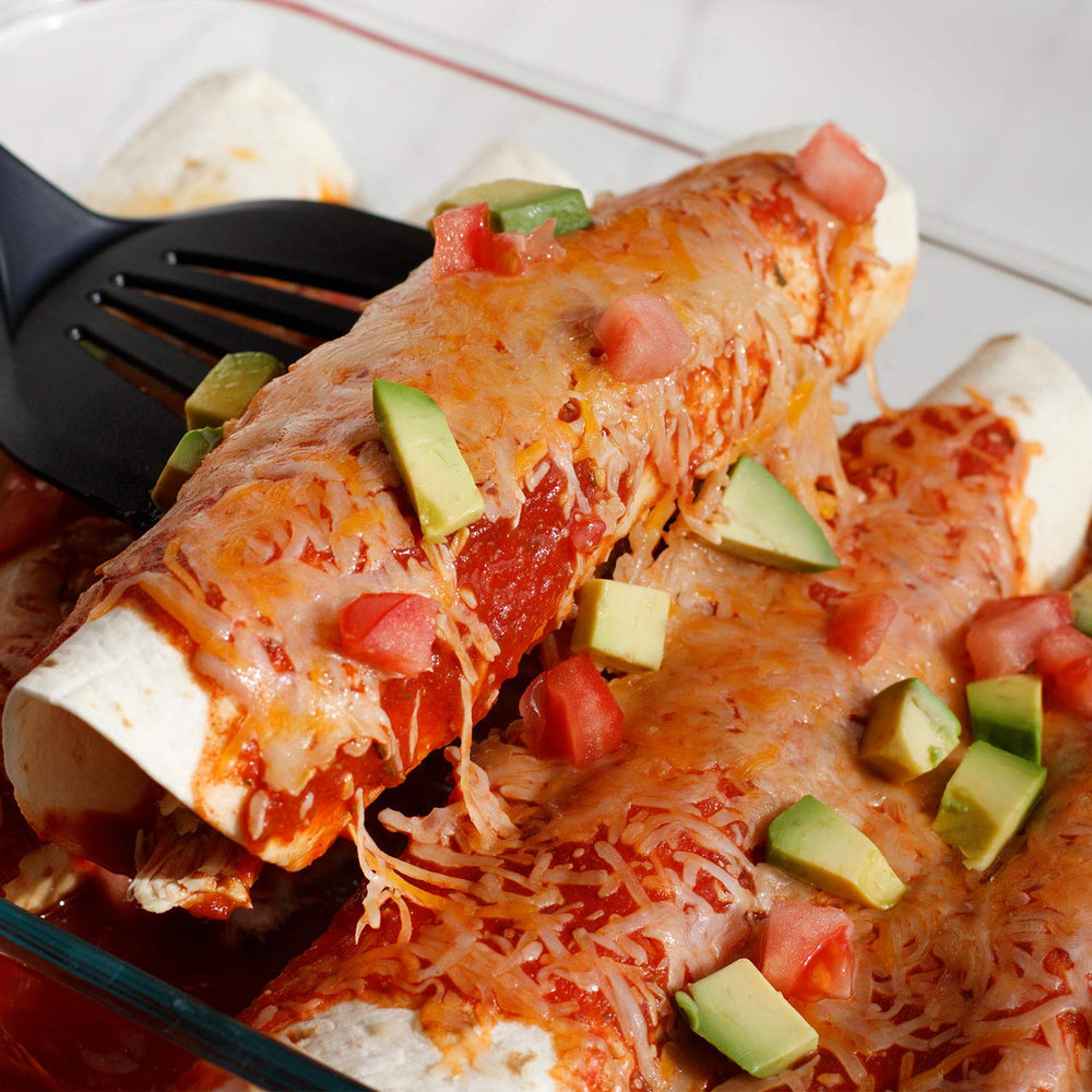 Golden baked enchiladas with melted cheese and sauce drizzle