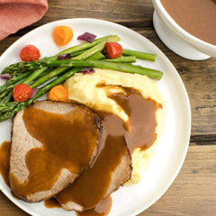 McCormick gluten-free brown gravy poured over mashed potatoes for serving