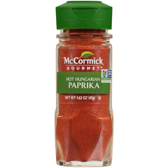 McCormick Gourmet Hot Hungarian Paprika bottle pour highlighting bold color and heat