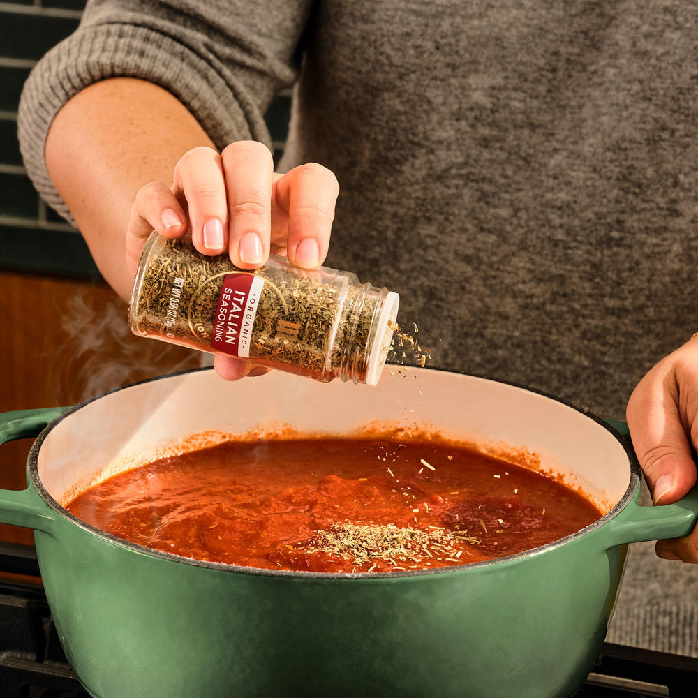 McCormick Gourmet Organic Italian Seasoning over a pizza slice scene