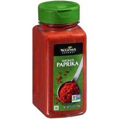 McCormick Gourmet Smoked Paprika bottle pour enhances smoky depth in grilled dishes.