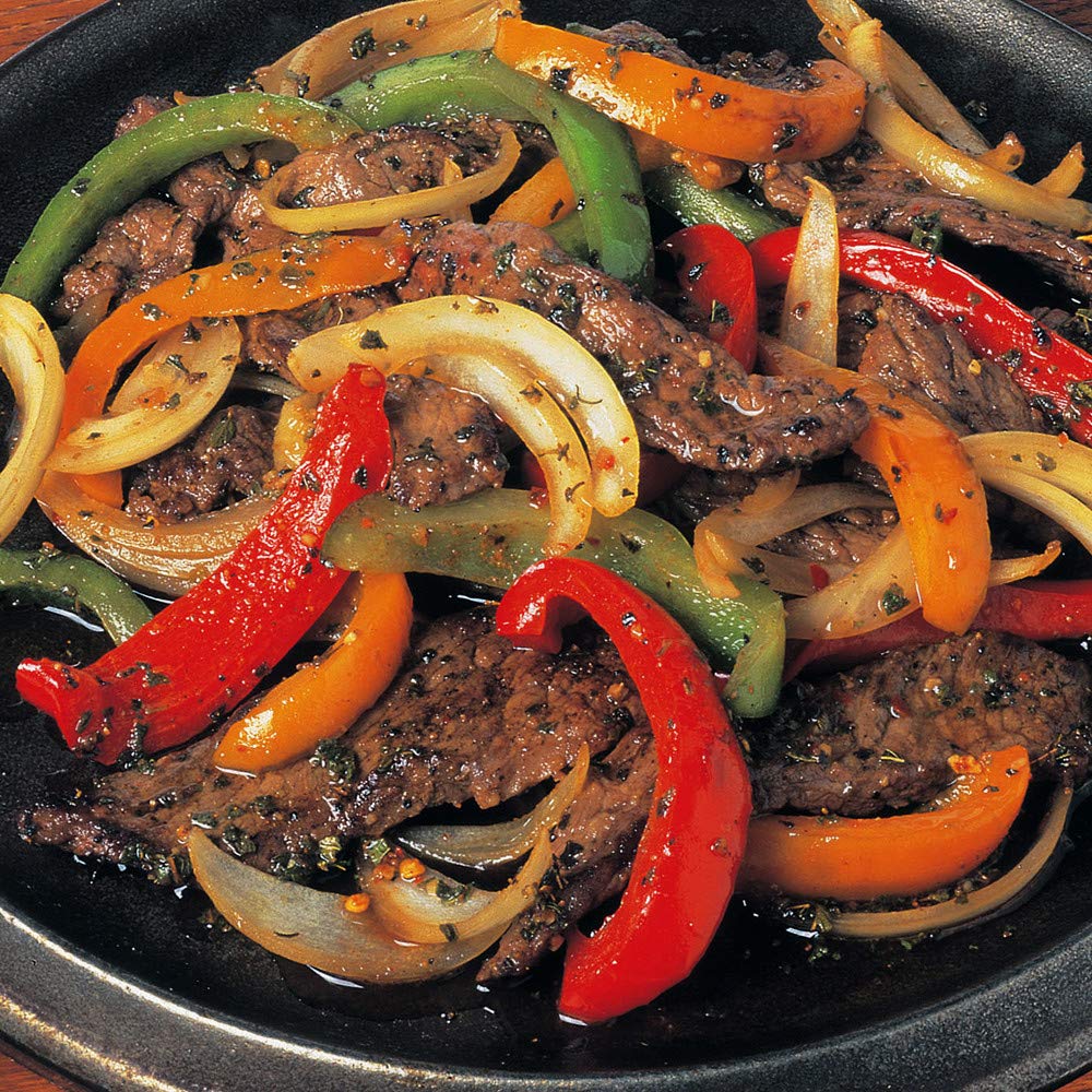 Open grill with seasoning bottle within reach for quick flavor boost