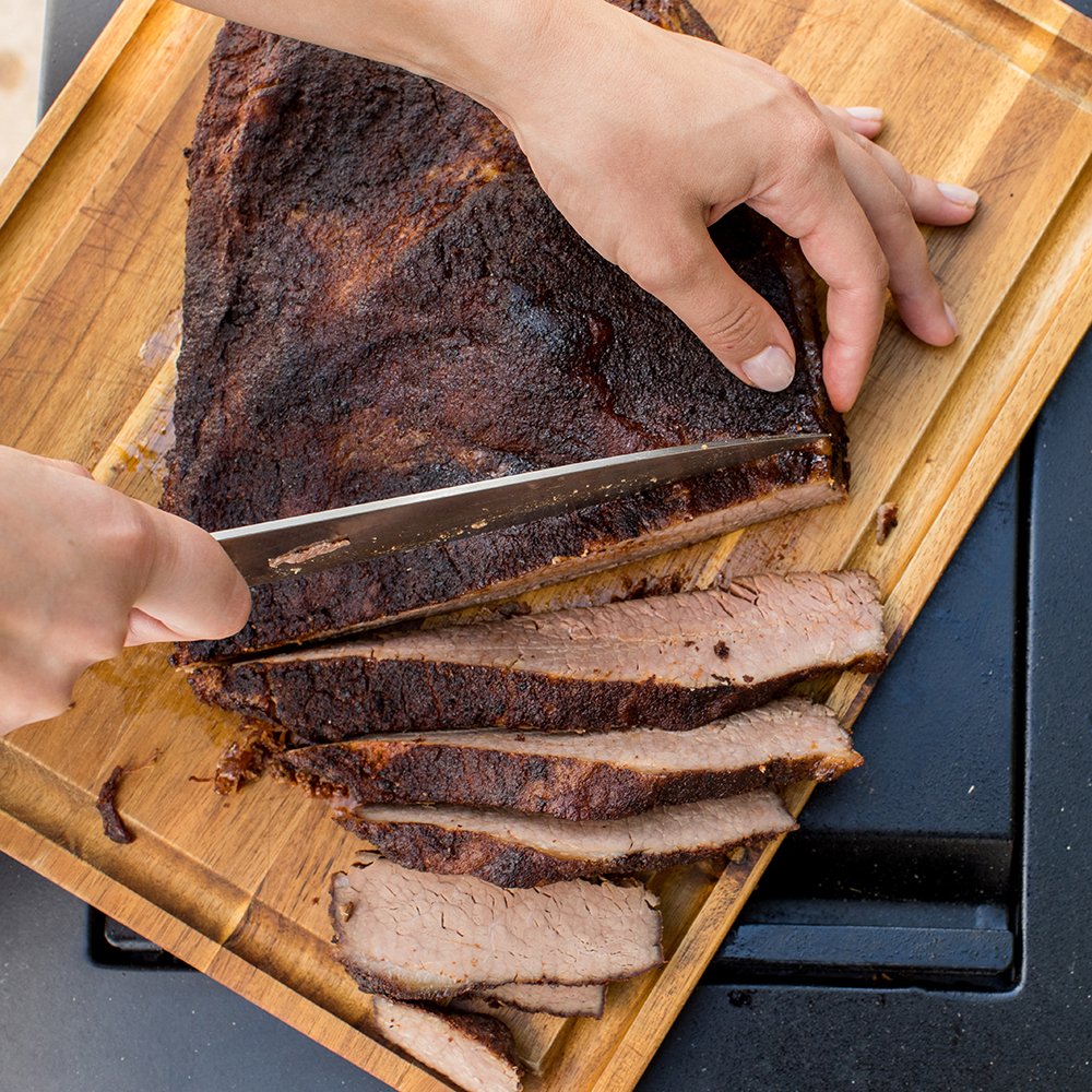 Smoldering grill scene with Mesquite Rub emitting mesquite aroma