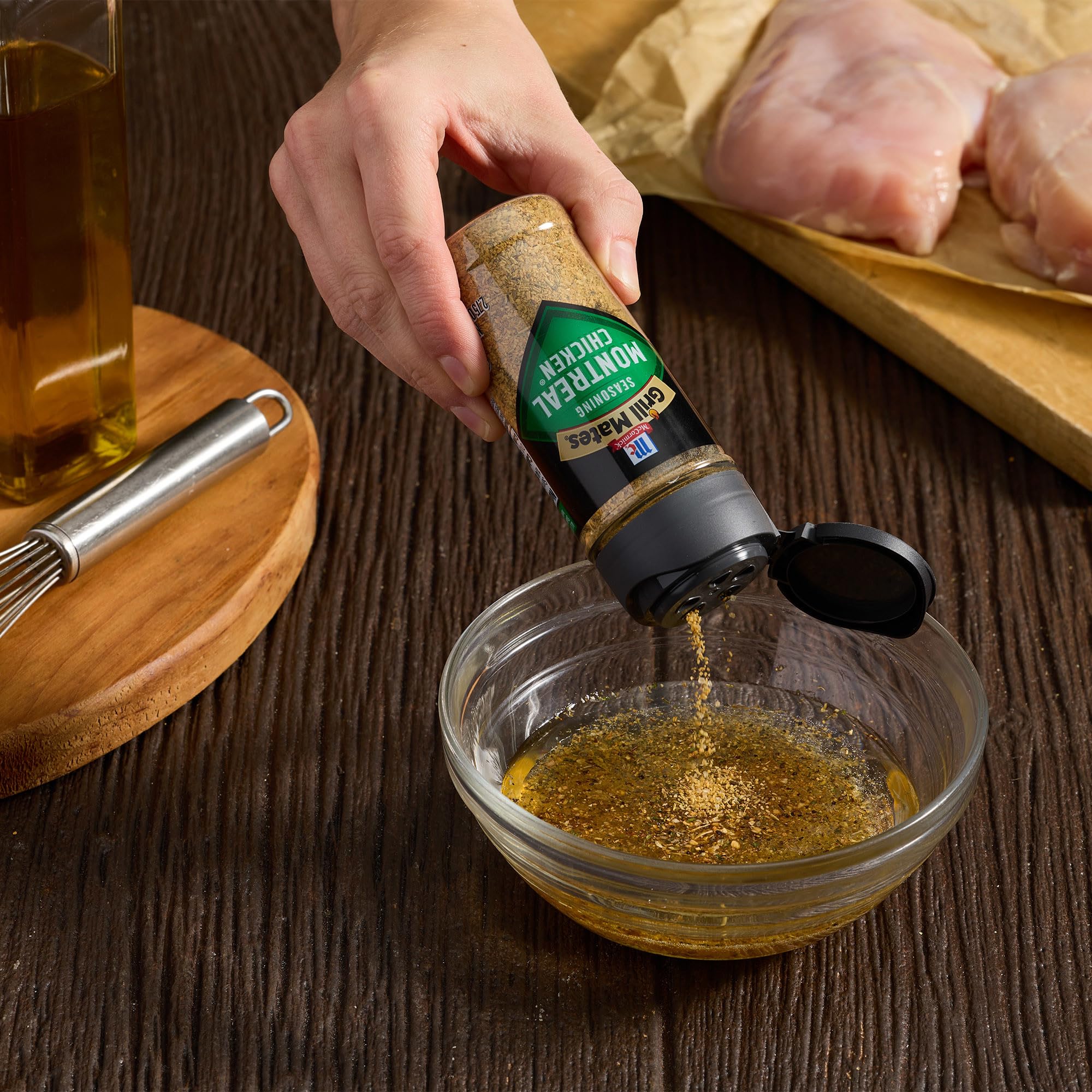 Seasoning shaker pours over chicken for easy prep