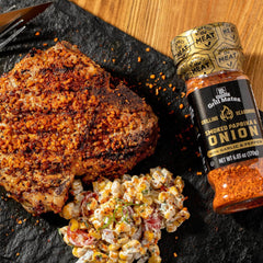 Seasoning shaker on a hot grill with grilled meat