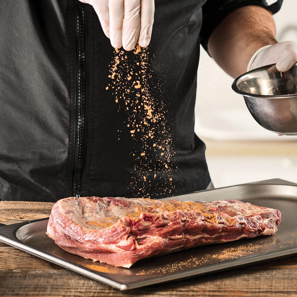 McCormick Grill Mates Smokehouse Maple sprinkled on chicken for robust flavor