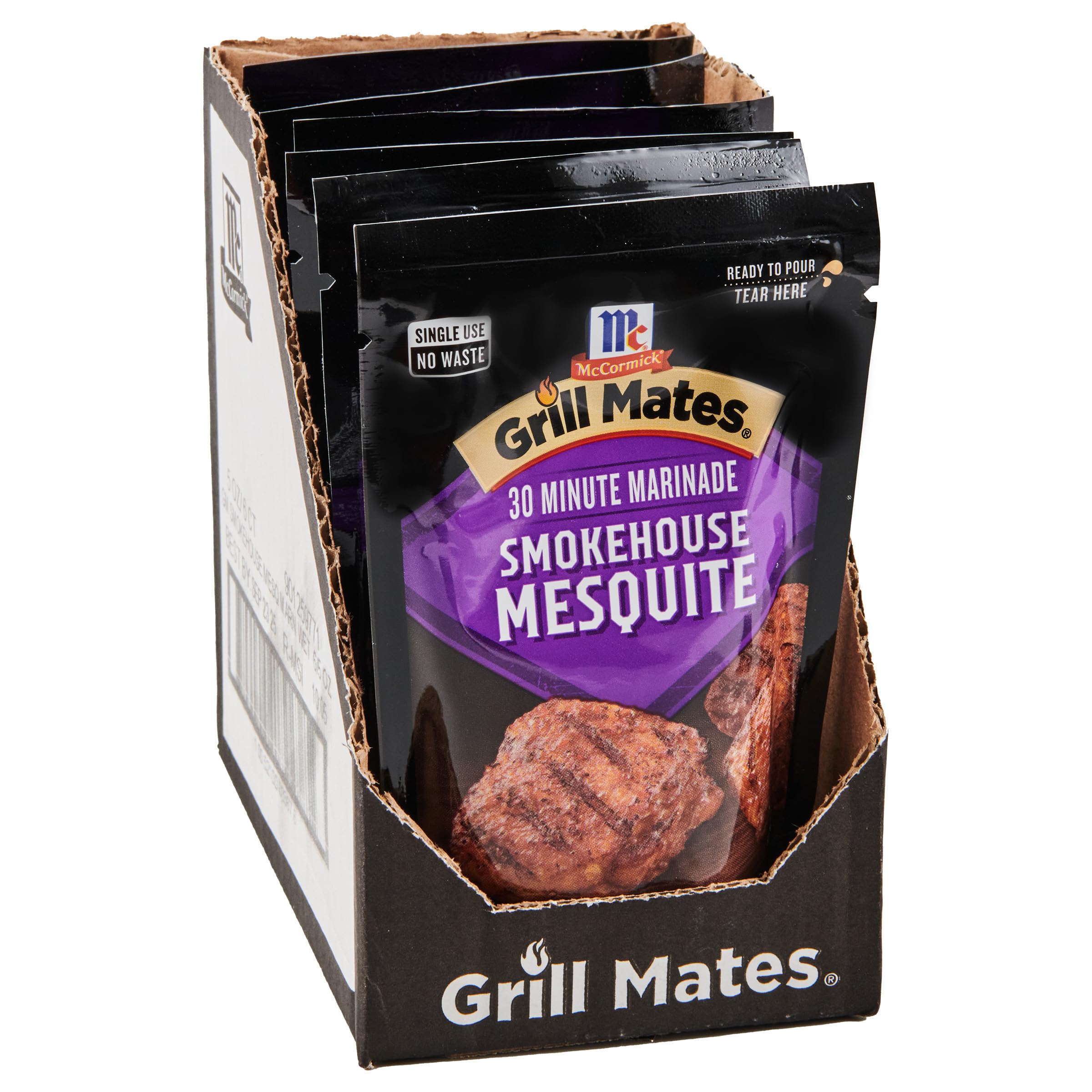 McCormick Grill Mates Smokehouse Mesquite bottle being poured for bold grilling flavor.