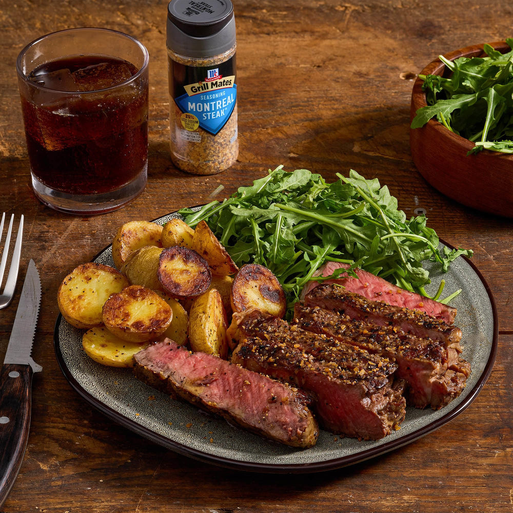 Sizzling steak on the grill using Montreal seasoning highlights flavor potential.