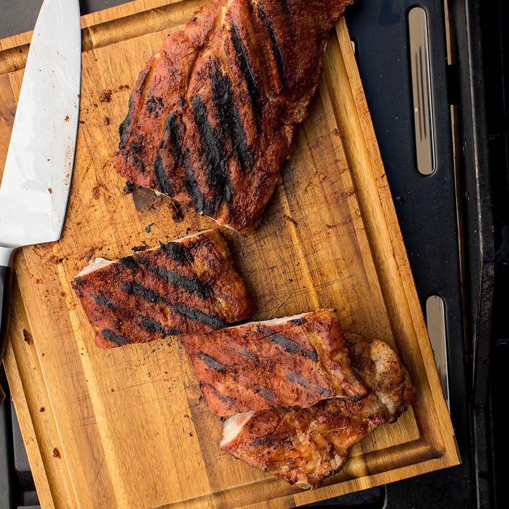 McCormick Grill Mates Sweet & Smoky Rub bottle on a grill with steaming smoke.