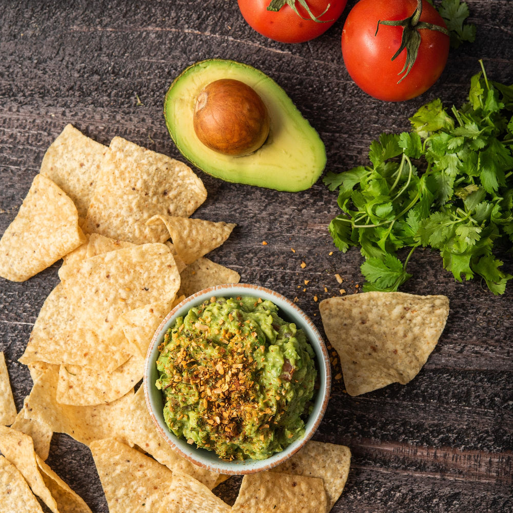 Chip plate with McCormick Guacamole Seasoning Dip for snacking.