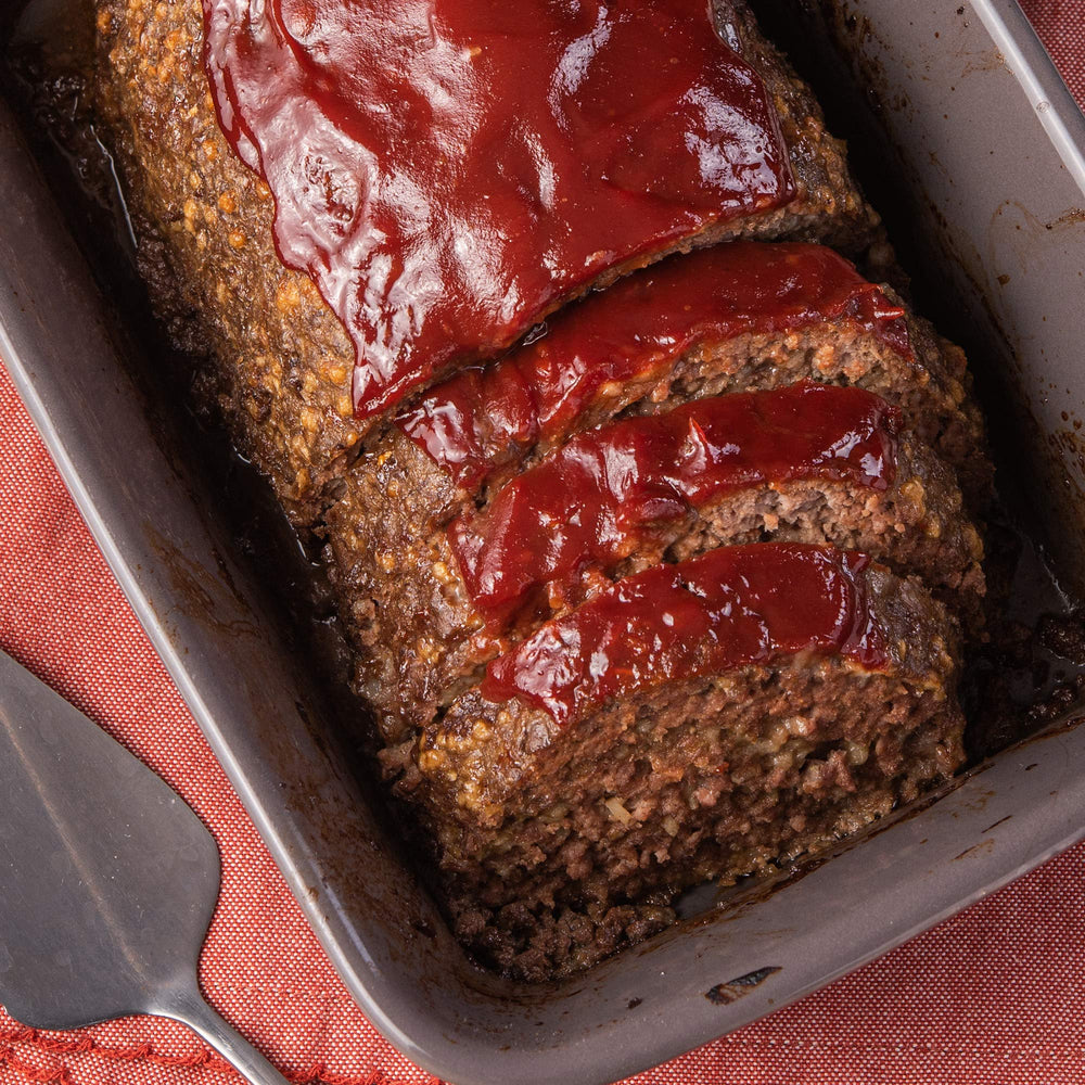 McCormick Meat Loaf Seasoning Mix raw-meatloaf-shaped prep scene.
