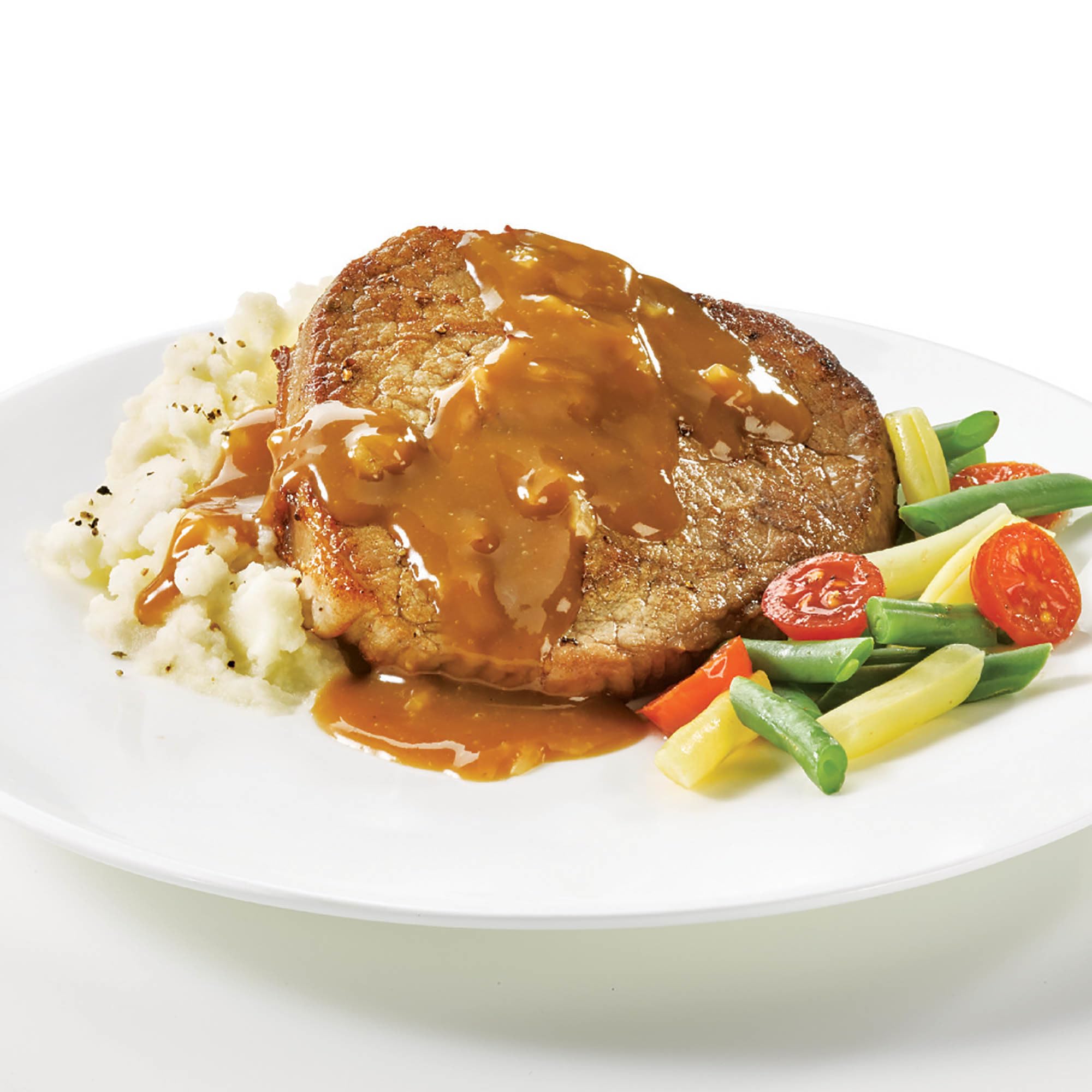 Onion gravy poured over meatloaf and sides.