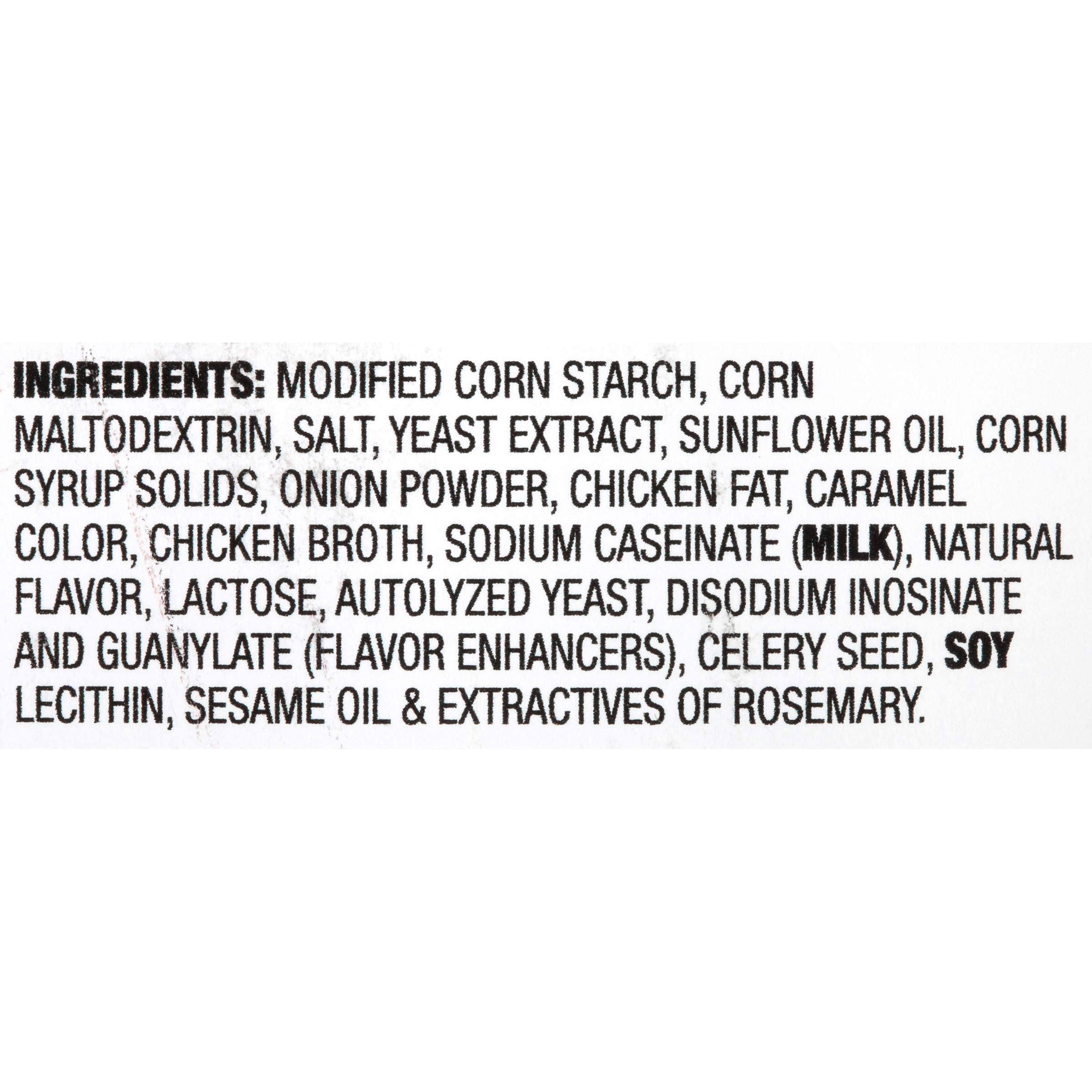 Pouring McCormick Poultry Gravy Mix into a saucepan for a smooth sauce.