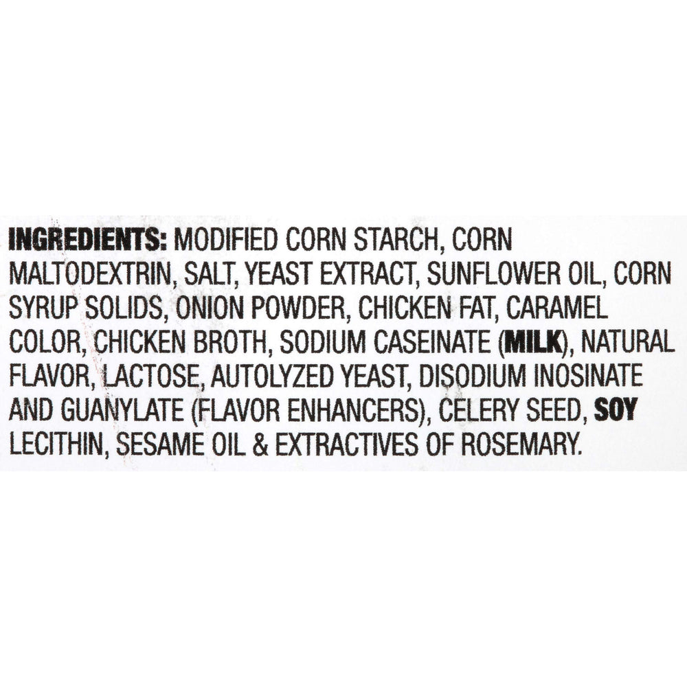 Pouring McCormick Poultry Gravy Mix into a saucepan for a smooth sauce.