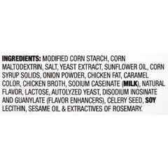 Pouring McCormick Poultry Gravy Mix into a saucepan for a smooth sauce.