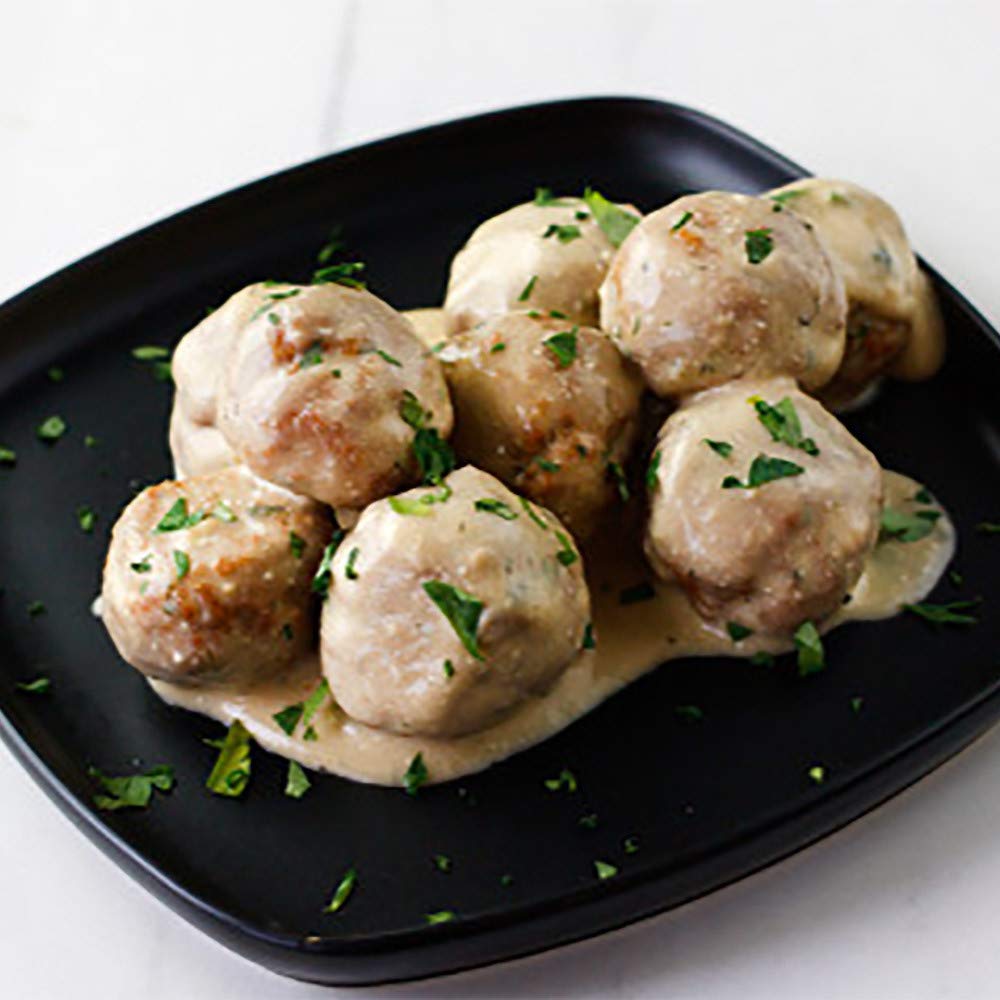 Serving tips over noodles featuring McCormick Swedish Meatballs for homestyle meals.