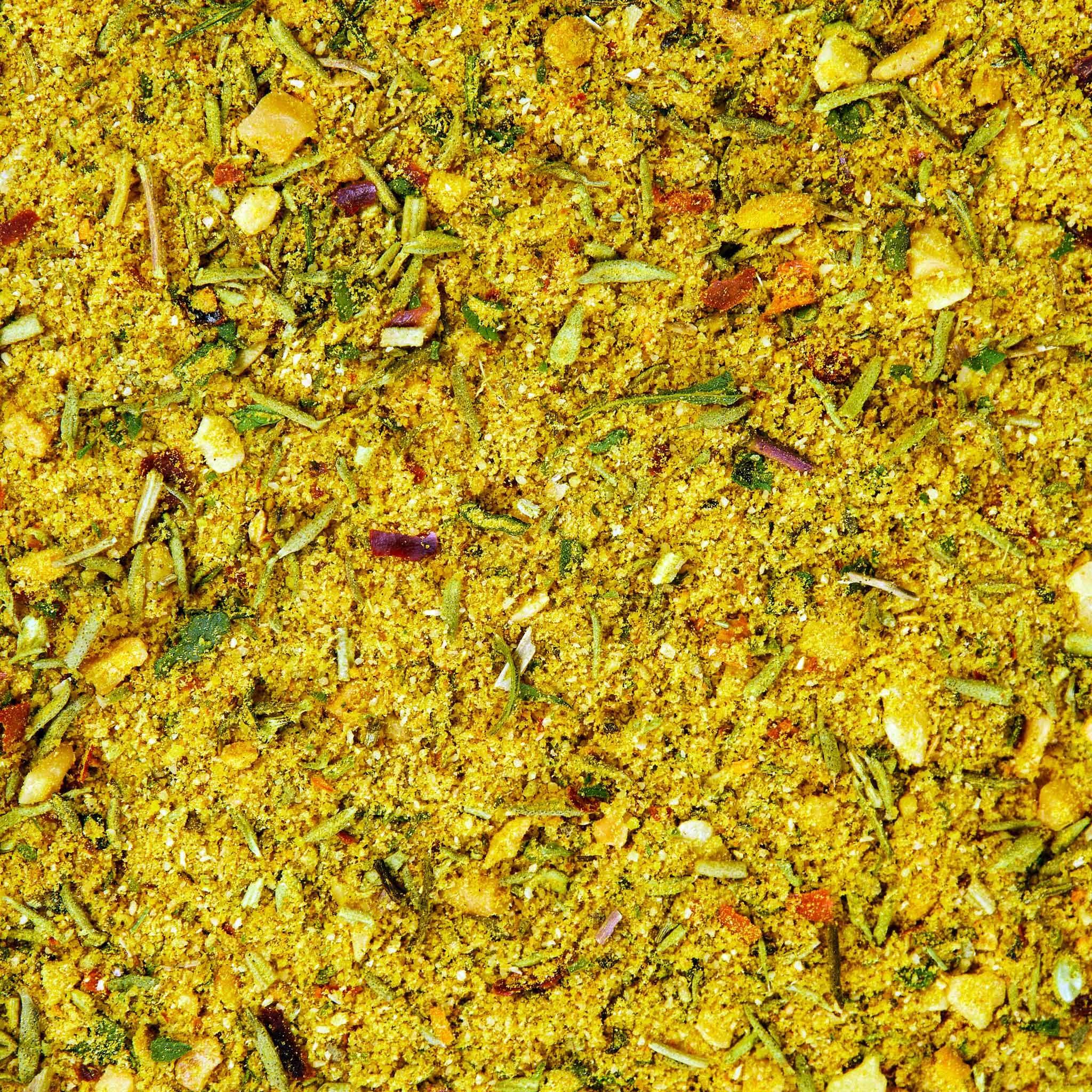 Spices drift over a colorful bowl in a bright kitchen.