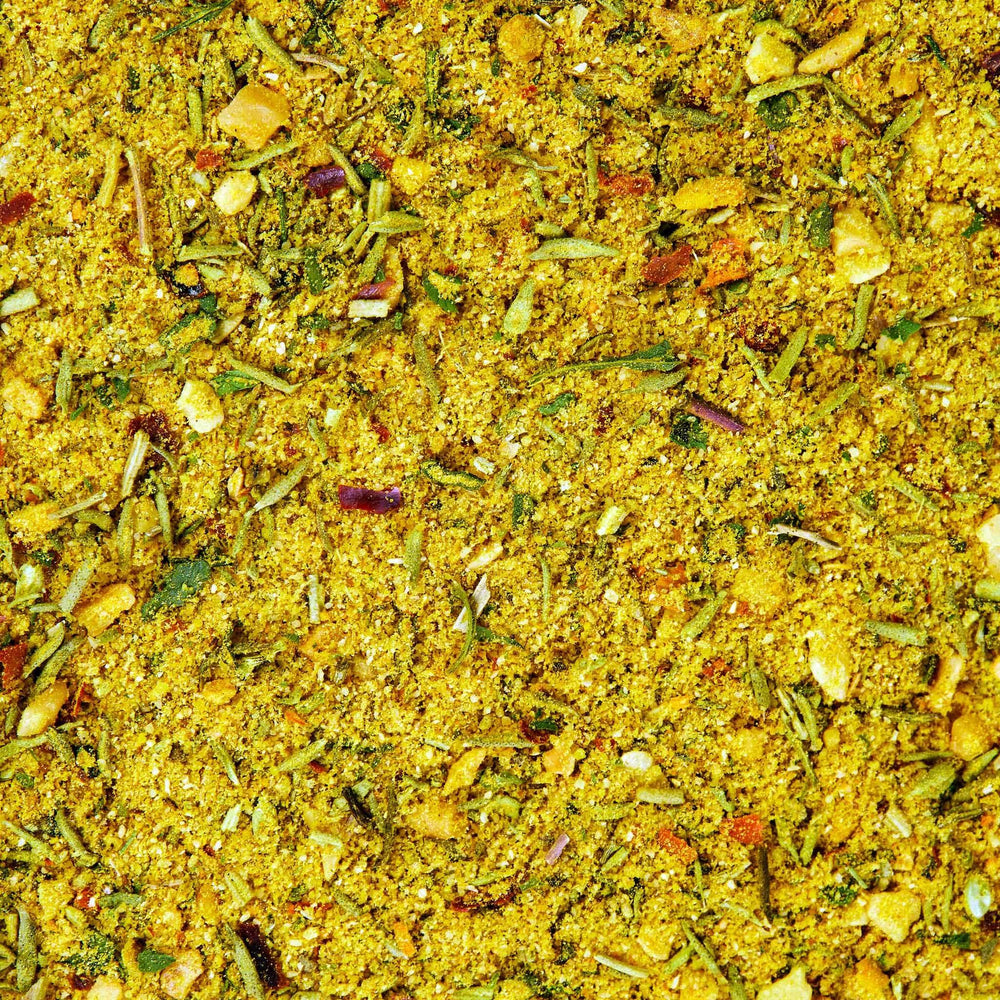 Spices drift over a colorful bowl in a bright kitchen.