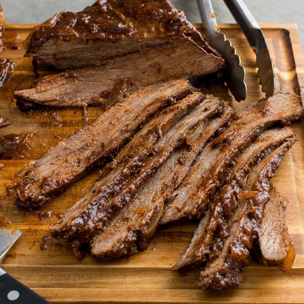 Kitchen scene with tenderized meat prepared by McCormick tenderizer ready to cook.
