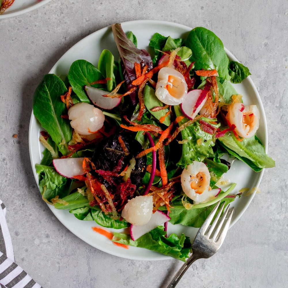 Mekoman lychee stir-fry shot shows sweet-savoury balance in a savory dish.