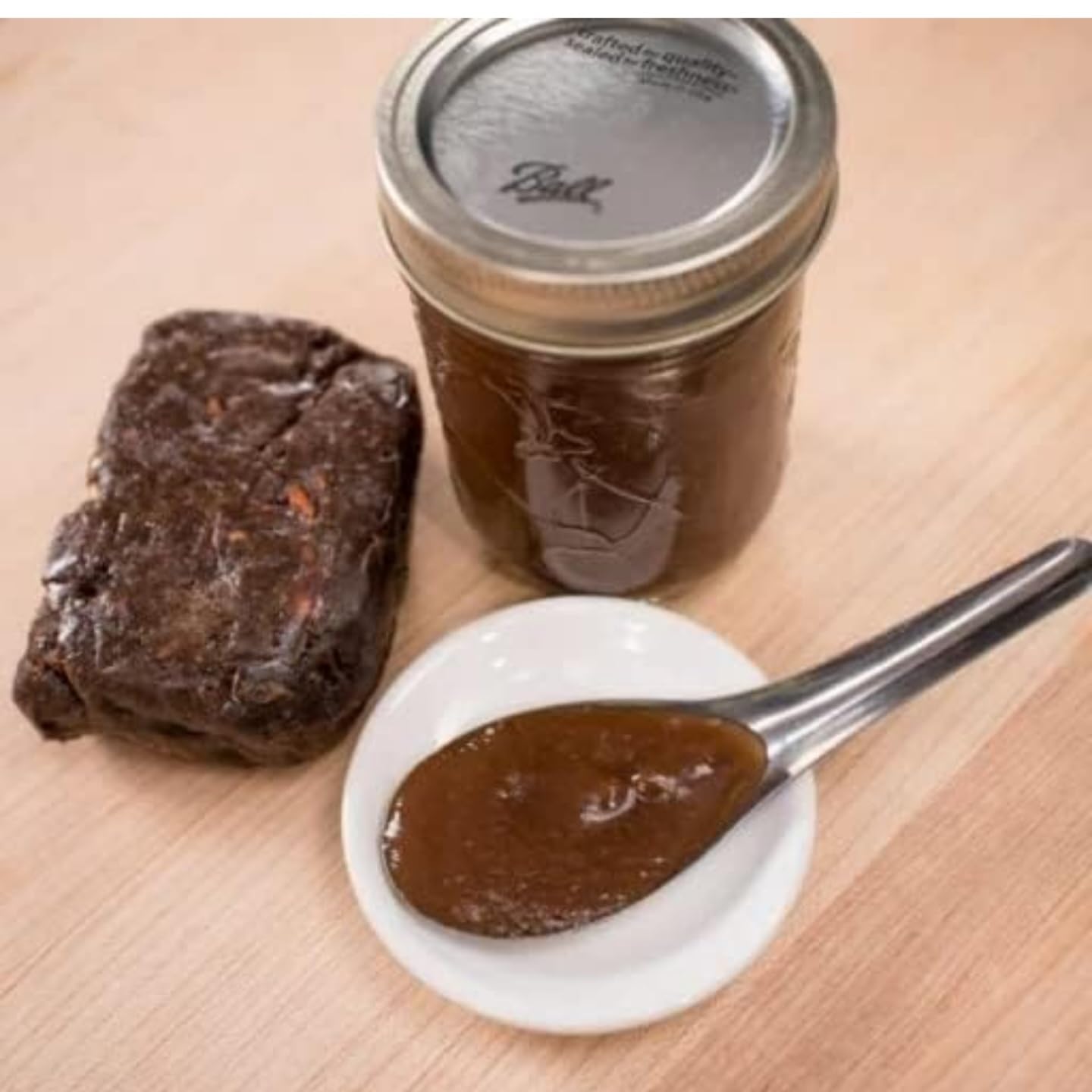Mekoman tamarind paste bottle pour showing smooth seedless paste ready to mix