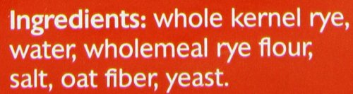 Close-up of whole rye kernels in Mestemacher bread, highlighting natural grains.