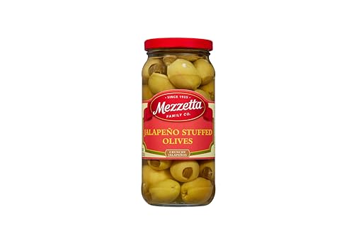 Closeup of glossy olives and jalapeno stuffing with crisp bite.