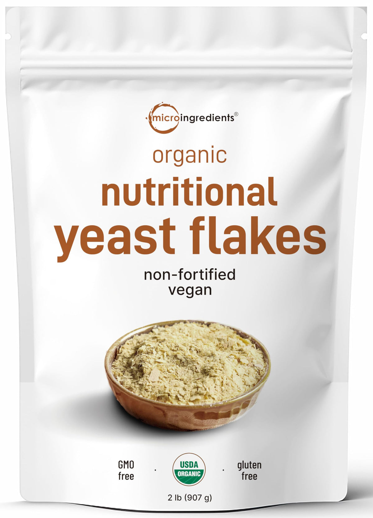 Micro Ingredients organic non-fortified nutritional yeast flakes bag poured over popcorn for savory flavor