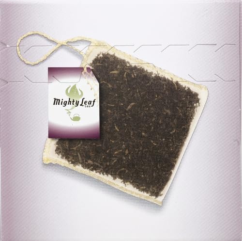 Pouring a cup of Mighty Leaf with milk enhances flavor.