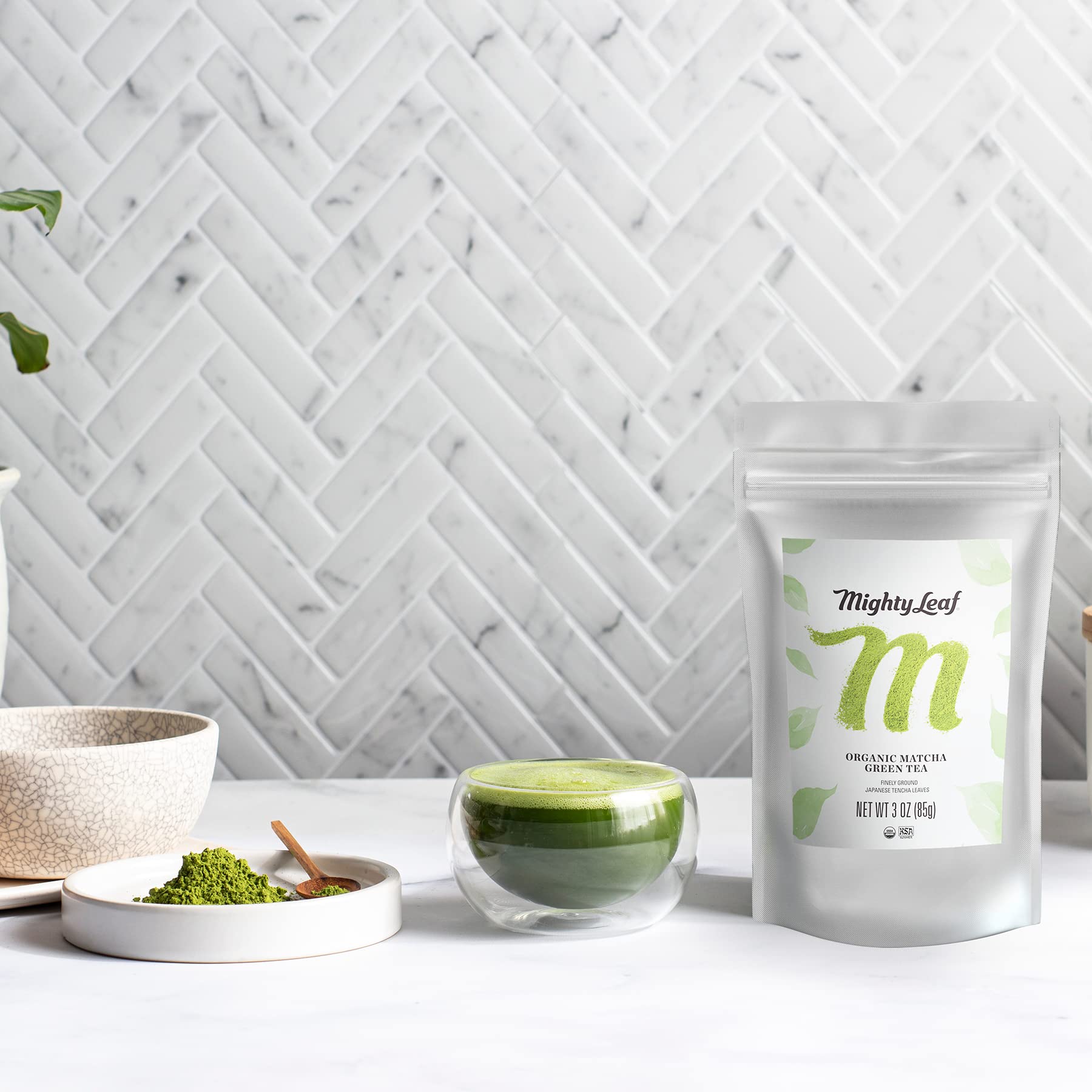 Mighty Leaf vibrant green matcha powder hue in a steaming cup